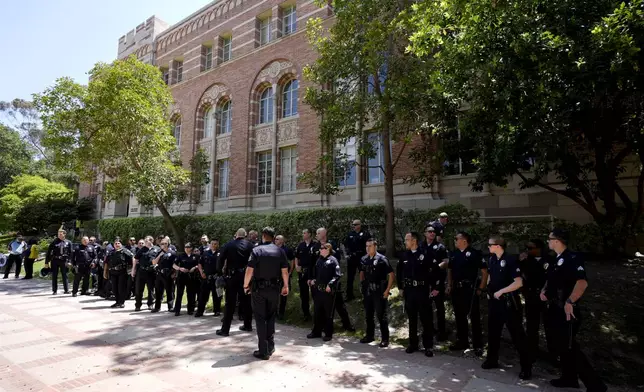 Police stage on the UCLA campus, after nighttime clashes between Pro-Israel and Pro-Palestinian groups, Wednesday, May 1, 2024, in Los Angeles. (AP Photo/Jae C. Hong)