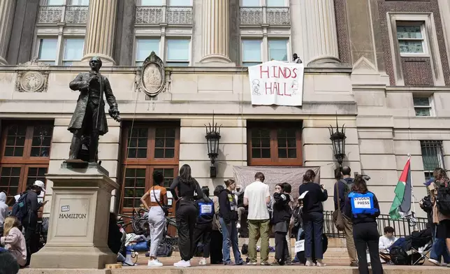 Student protesters camp near the entrance to Hamilton Hall on the campus of Columbia University, Tuesday, April 30, 2024, in New York. Early Tuesday, dozens of protesters took over Hamilton Hall, locking arms and carrying furniture and metal barricades to the building. Columbia responded by restricting access to campus. (AP Photo/Mary Altaffer, Pool)