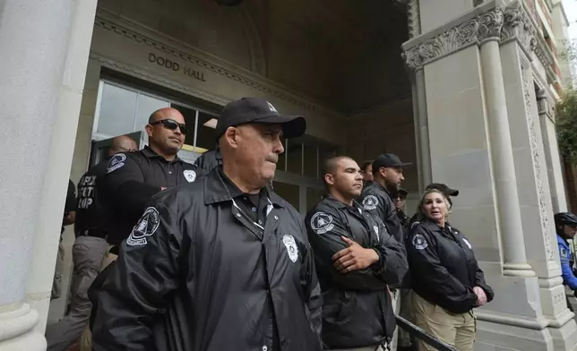 University security officers block pro-Palestinian demonstrators from Dodd Hall on the campus of UCLA in Los Angeles, Thursday, May 23, 2024. (AP Photo/Damian Dovarganes)