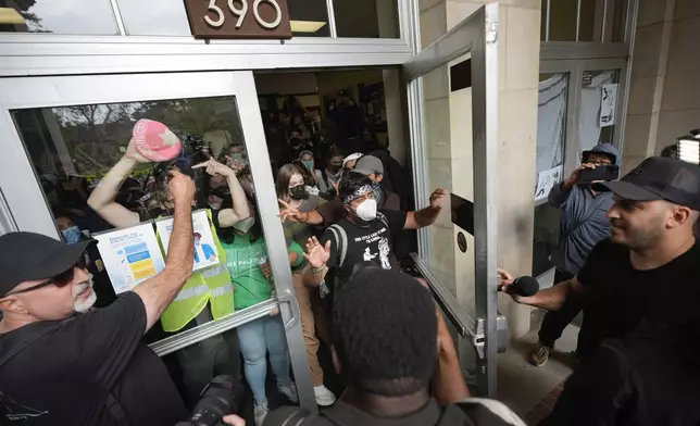 Pro-Palestinian demonstrators disperse from Dodd Hall as requested by the police on the UCLA campus on Thursday, May 23, 2024, in Los Angeles. (AP Photo/Ryan Sun)