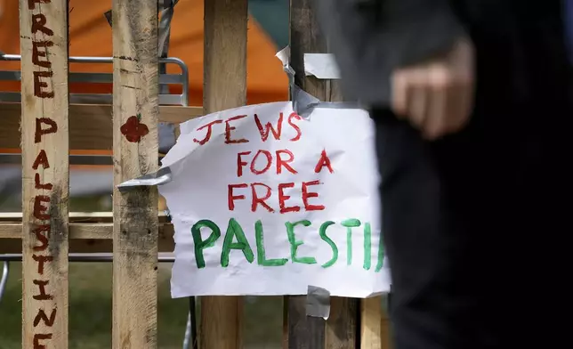 A sign is seen on the fence in a pro-Palestinian encampment at Main Quadrangle on the University of Chicago campus, Monday, May 6, 2024, in Chicago. (AP Photo/Nam Y. Huh)