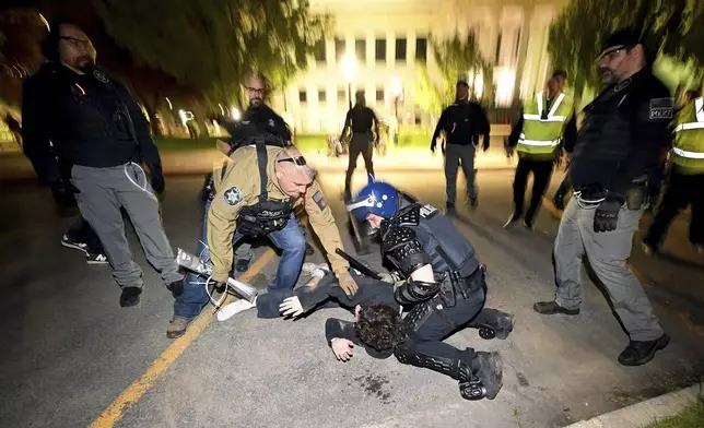 Police move in and make arrests on demonstrators gathered to show support for Palestinians at the University of Utah in Salt Lake City, Monday, April 29, 2024. (Scott G Winterton/The Deseret News via AP)