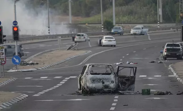 FILE - A car destroyed in an attack by Palestinian militants is seen in Sderot, Israel, on Saturday, Oct. 7, 2023. (AP Photo/Ohad Zwigenberg, File)