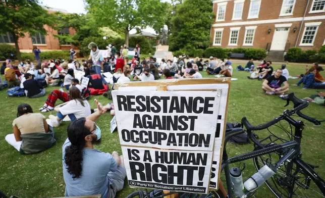 Dozens of pro-Palestinian protesters seat down at the Old Campus after they rally at the University of Georgia, Athens, campus in Athens, Ga., following arrests on Monday, April 29, 2024. (Miguel Martinez/Atlanta Journal-Constitution via AP)