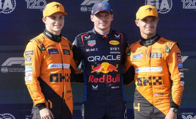 Red Bull driver Max Verstappen of the Netherlands, center, poses with McLaren driver Oscar Piastri of Australia, left, and McLaren driver Lando Norris of Britain after the qualifying session for the Italy's Emilia Romagna Formula One Grand Prix at the Dino and Enzo Ferrari racetrack in Imola, Italy, Saturday, May 18, 2024. (AP Photo/Luca Bruno)