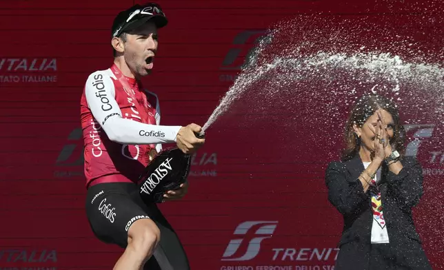 France's Benjamin Thomas celebrates on podium after winning the fifth stage of the Giro d'Italia, Tour of Italy cycling race, from Genoa to Lucca, Wednesday, May 8, 2024. (Gian Mattia D'Alberto/LaPresse via AP)
