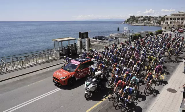 The pack rides along the coastline during the fifth stage of the of the Giro d'Italia, Tour of Italy cycling race, from Genoa to Lucca, Wednesday, May 8, 2024. (Fabio Ferrari/LaPresse via AP)