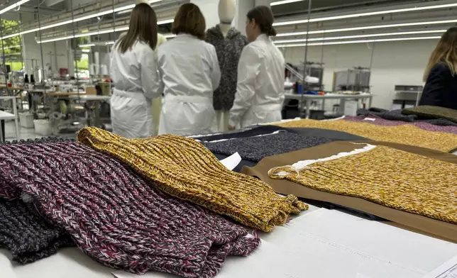 Knitwear created by Italian artisans for the Prada and Miu Miu brands sit on a desk at a recently expanded factory in the Perugia province of Italy, Tuesday, May 7, 2024. The Prada Group is expanding its production footprint in Italy, including dozens of new jobs at brand's knitwear factory near Umbria, leaning into Made in Italy as integral to the brand's ethos as it develops new artisanal talent to ease the luxury group through a generational shift in its workforce, alongside the management and creative transitions already under way. (AP Photo/Colleen Barry)