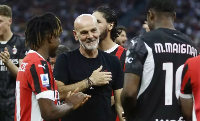 AC Milan manager Stefano Pioli, center, celebrates after the Serie A soccer match between Milan and Salernitana at the Giuseppe Meazza Stadium in Milan, Italy, Saturday, May 25, 2024. (Alberto Mariani/LaPresse via AP)