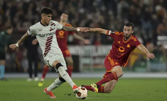 Leverkusen's Granit Xhaka, left, and Roma's Bryan Cristante fight for the ball during the UEFA Europa League semifinal first leg soccer match between AS Roma and Bayer 04 Leverkusen at the Olympic stadium in Rome, Italy, Thursday, May 2, 2024. (Alfredo Falcone/LaPresse via AP)
