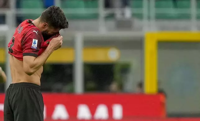 AC Milan's Olivier Giroud reacts after AC Milan's Malick Thiaw scores an own goal past his goalkeeper during a Serie A soccer match between AC Milan and Genoa, at the San Siro stadium in Milan, Italy, Sunday, May 5, 2024. (AP Photo/Luca Bruno)