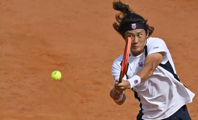 China's Zhang Zhizhen returns the ball to Chile's Alejandro Tabilo during the quarterfinal match at the Italian Open tennis tournament at Rome's Foro Italico, Wednesday, May 15, 2024. (AP Photo/Antonietta Baldassarre)