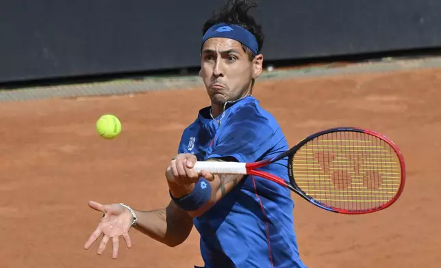 Chile's Alejandro Tabilo returns the ball to China's Zhang Zhizhen during the quarterfinal match at the Italian Open tennis tournament at Rome's Foro Italico, Wednesday, May 15, 2024. (AP Photo/Antonietta Baldassarre)