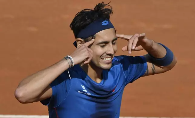 Chile's Alejandro Tabilo celebrates after defeating China's Zhang Zhizhen in the quarterfinal match at the Italian Open tennis tournament at Rome's Foro Italico, Wednesday, May 15, 2024. (AP Photo/Antonietta Baldassarre)