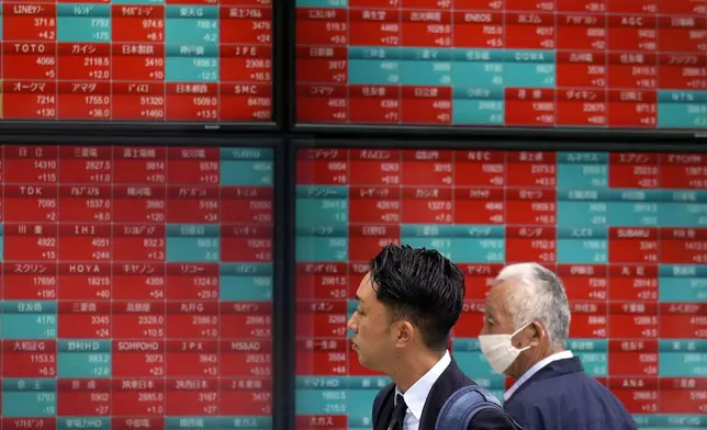 People look at an electronic stock board showing Japan's Nikkei 225 index at a securities firm Thursday, May 9, 2024, in Tokyo. (AP Photo/Eugene Hoshiko)