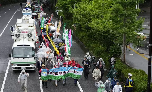 Participants march after a May Day rally in Tokyo, Wednesday, May 1, 2024. (AP Photo/Hiro Komae)