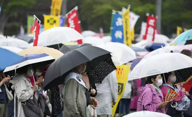 People listen to a speaker during a May Day rally in Tokyo, Wednesday, May 1, 2024. (AP Photo/Hiro Komae)