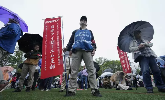 People listen to a speaker during a May Day rally in Tokyo, Wednesday, May 1, 2024. (AP Photo/Hiro Komae)