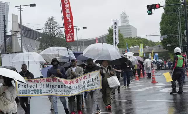 Participants march after a May Day rally in Tokyo, Wednesday, May 1, 2024. (AP Photo/Hiro Komae)