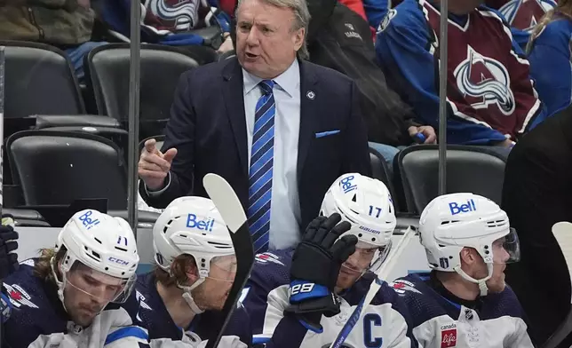 Winnipeg Jets head coach Rick Bowness, center top, directs his team in the second period of Game 4 of an NHL Stanley Cup first-round playoff series against the Colorado Avalanche, Sunday, April 28, 2024, in Denver. (AP Photo/David Zalubowski)