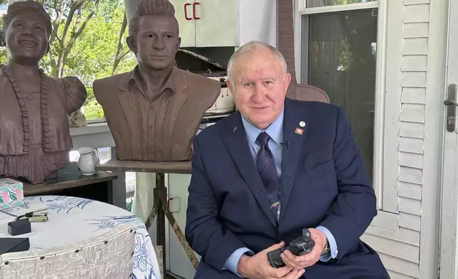 Arkansas State Sen. David Wallace holds a small-scale statue of Johnny Cash, on April 23, 2024, in Little Rock, Ark. Artist Kevin Kresse's full sculpture of Cash will be unveiled at the U.S Capitol as part of the Statuary Hall collection, later this year. (AP Photo/Andrew DeMillo)
