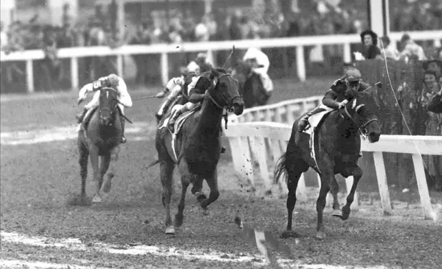 FILE - Citation, center, with Eddie Arcaro in the saddle, comes up on Coaltown, right, during the Kentucky Derby in Louisville, Ky., May 1, 1948. America’s longest continuously held sporting event turns 150 years old Saturday. The Kentucky Derby has survived two world wars, the Depression and pandemics, including COVID-19 in 2020, when it ran in virtual silence without the usual crowd of 150,000.(AP Photo/File)