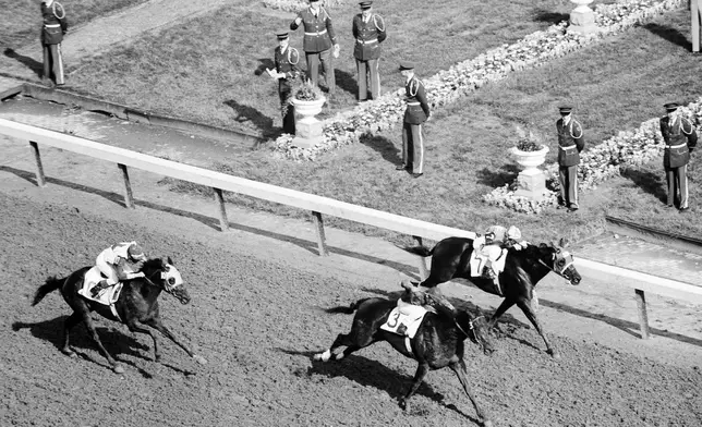 FILE - Tim Tam goes from even-Stephen with Lincoln Road (7) to finish half a length ahead at the wire in at the Kentucky Derby, May 3, 1958 in Louisville, Ky. America’s longest continuously held sporting event turns 150 years old Saturday. The Kentucky Derby has survived two world wars, the Depression and pandemics, including COVID-19 in 2020, when it ran in virtual silence without the usual crowd of 150,000.(AP Photo/File)