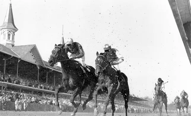 FILE - Lucky Debonair and jockey Bill Shoemaker are seen coming ahead in the final challenge to win the Kentucky Derby at Churchill Downs in Louisville, Ky., on May 1, 1965. America’s longest continuously held sporting event turns 150 years old Saturday. The Kentucky Derby has survived two world wars, the Depression and pandemics, including COVID-19 in 2020, when it ran in virtual silence without the usual crowd of 150,000. (AP Photo/File)