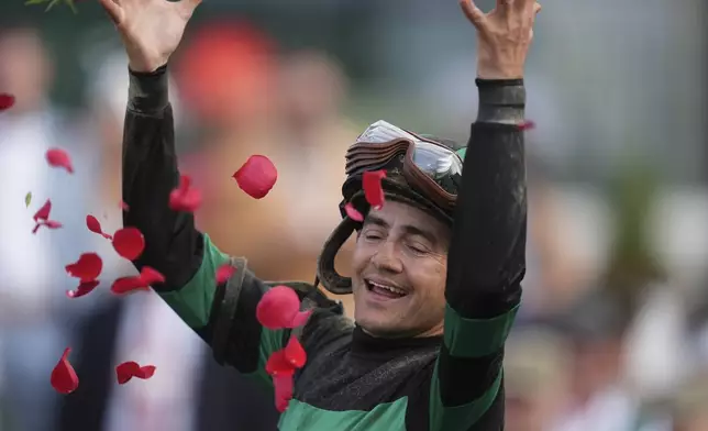 Brian Hernandez Jr. celebrates in the winner's circle after riding Mystik Dan to win the 150th running of the Kentucky Derby horse race at Churchill Downs Saturday, May 4, 2024, in Louisville, Ky. (AP Photo/Abbie Parr)