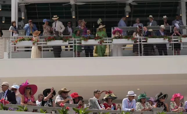 Race fans watch the paddock at Churchill Downs before the 150th running of the Kentucky Derby horse race Saturday, May 4, 2024, in Louisville, Ky. (AP Photo/Brynn Anderson)