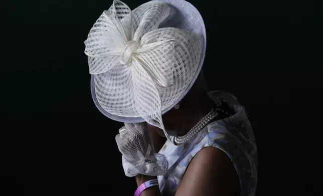 A race fan walks through the stands at Churchill Downs before the 150th running of the Kentucky Derby horse race Saturday, May 4, 2024, in Louisville, Ky. (AP Photo/Brynn Anderson)