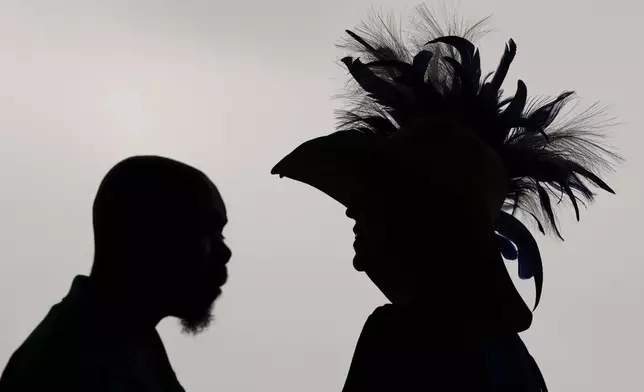 Race fans walk though the stands Churchill Downs before the 150th running of the Kentucky Derby horse race Saturday, May 4, 2024, in Louisville, Ky. (AP Photo/Charlie Riedel)