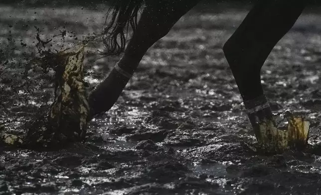 A horse throws up mud on the track at Churchill Downs, Friday, May 3, 2024, in Louisville, Ky. The 150th running of the Kentucky Derby is scheduled for Saturday, May 4. (AP Photo/Brynn Anderson)