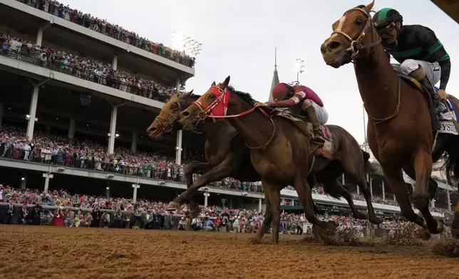 Brian Hernandez Jr. rides Mystik Dan, right, runs to the finish line to win the 150th running of the Kentucky Derby horse race at Churchill Downs Saturday, May 4, 2024, in Louisville, Ky. (AP Photo/Jeff Roberson)