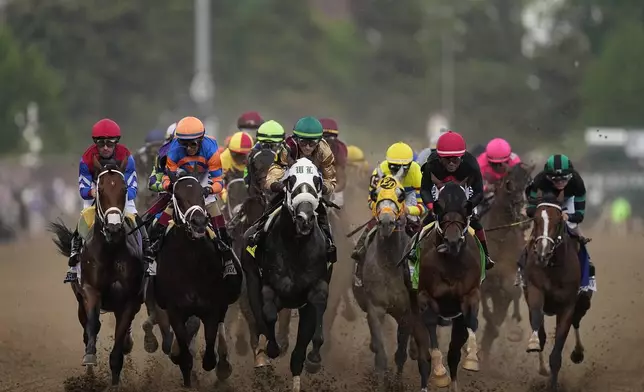 Brian Hernandez Jr. rides Mystik Dan, right, to the finish line to win the 150th running of the Kentucky Derby horse race at Churchill Downs Saturday, May 4, 2024, in Louisville, Ky. (AP Photo/Brynn Anderson)