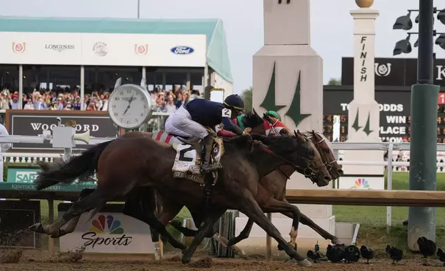 Sierra Leone, with jockey Tyler Gaffalione, (2), Forever Young, with jockey Ryusei Sakai, and Mystik, with jockey Dan Brian Hernandez Jr., cross finish line at Churchill Downs during the 150th running of the Kentucky Derby horse race Saturday, May 4, 2024, in Louisville, Ky. (AP Photo/Kiichiro Sato)