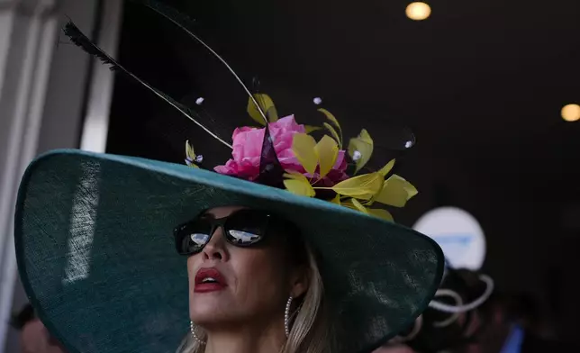 A race fan watches race at Churchill Downs before the 150th running of the Kentucky Derby horse race Saturday, May 4, 2024, in Louisville, Ky. (AP Photo/Brynn Anderson)