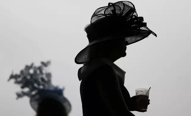Race fans walk though the stands at Churchill Downs before the 150th running of the Kentucky Derby horse race Saturday, May 4, 2024, in Louisville, Ky. (AP Photo/Charlie Riedel)
