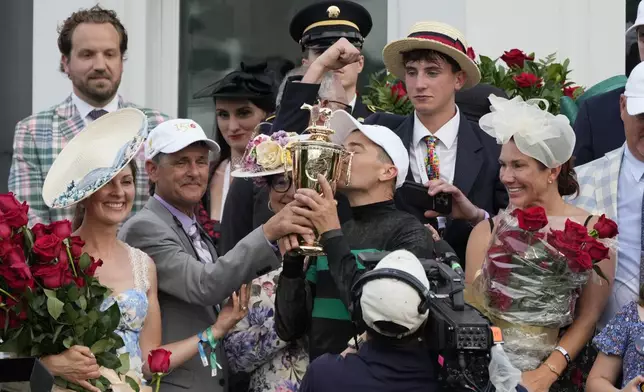 Brian Hernandez Jr. celebrates in the winner's circle after riding Mystik Dan to win the 150th running of the Kentucky Derby horse race at Churchill Downs Saturday, May 4, 2024, in Louisville, Ky. (AP Photo/Jeff Roberson)