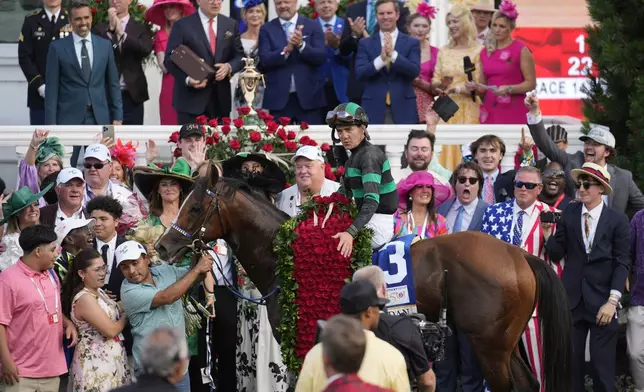 Brian Hernandez Jr. celebrates in the winner's circle after riding Mystik Dan to win the 150th running of the Kentucky Derby horse race at Churchill Downs Saturday, May 4, 2024, in Louisville, Ky. (AP Photo/Jeff Roberson)