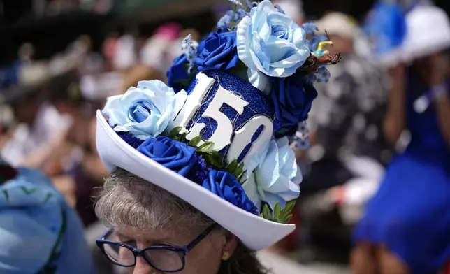A race fan sits in the stands at Churchill Downs before the 150th running of the Kentucky Derby horse race Saturday, May 4, 2024, in Louisville, Ky. (AP Photo/Brynn Anderson)
