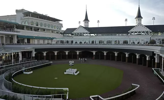 Visitors check out the new $200 million paddock at Churchill Downs Thursday, May 2, 2024, in Louisville, Ky. The 150th running of the Kentucky Derby is scheduled for Saturday, May 4. (AP Photo/Charlie Riedel)