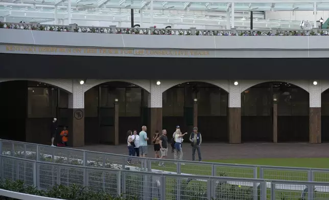 Visitors check out the new $200 million paddock at Churchill Downs Thursday, May 2, 2024, in Louisville, Ky. The 150th running of the Kentucky Derby is scheduled for Saturday, May 4. (AP Photo/Charlie Riedel)