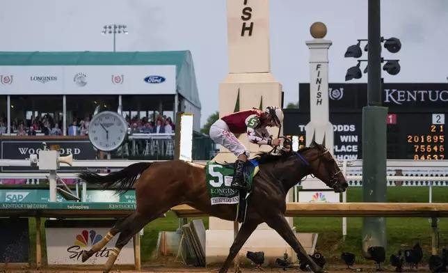 Brian Hernandez Jr. rides Thorpedo Anna (5) to win the 150th running of the Kentucky Oaks horse race Churchill Downs Friday, May 3, 2024, in Louisville, Ky. (AP Photo/Kiichiro Sato)