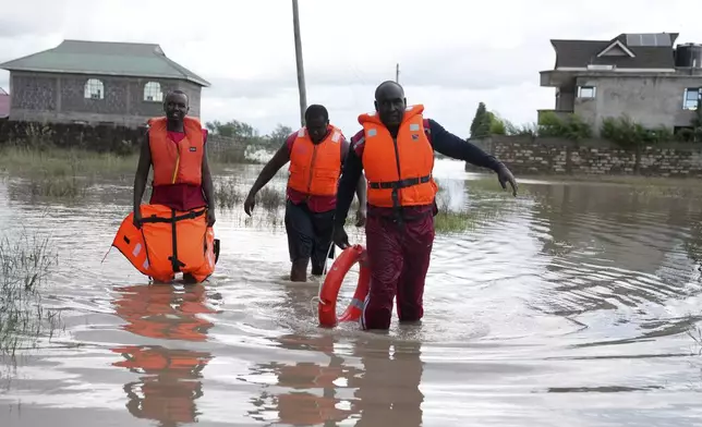FILE - Kenyan Red Cross personnel and volunteers conduct search and rescue missions, around houses submerged by flood water in Machakos county, Kenya, April 22, 2024. (AP Photo/Brian Inganga, File)