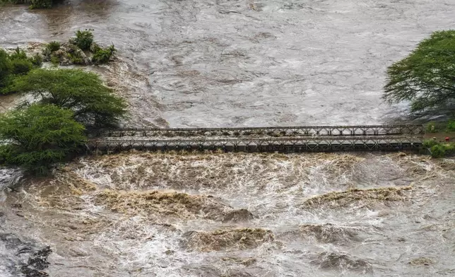 Flood waters cover a bridge in the flooded Maasai Mara National Reserve, that left dozens of tourists stranded in Narok County, Kenya, Wednesday, May 1, 2024. Kenya, along with other parts of East Africa, has been overwhelmed by flooding. (AP Photo/Bobby Neptune)