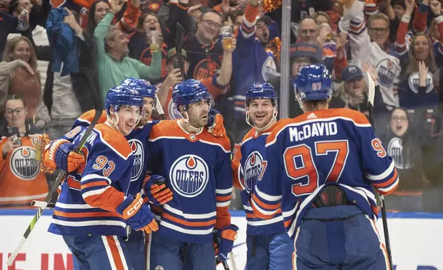 Edmonton Oilers' Ryan Nugent-Hopkins (93), Leon Draisaitl (29), Evan Bouchard (2), Zach Hyman (18) and Connor McDavid (97) celebrate a goal against the Los Angeles Kings during the second period in Game 5 of an NHL hockey Stanley Cup first-round playoff series, on Wednesday May 1, 2024, in Edmonton, Alberta. (Jason Franson/The Canadian Press via AP)