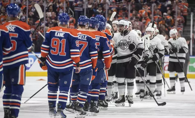 Los Angeles Kings and the Edmonton Oilers players shake hands after the Oilers won Game 5 of an NHL hockey Stanley Cup first-round playoff series, on Wednesday May 1, 2024, in Edmonton, Alberta. (Jason Franson/The Canadian Press via AP)