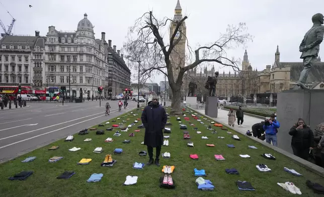 FILE - British Actor Idris Elba stands in Parliament Square with clothing representing the human cost of UK knife crimes in London on Jan. 8, 2024, as he calls on the government to take immediate action. Knife crimes are on the rise in England and Wales, and a string of deadly attacks in recent years has stoked public anxiety and led to calls for the government to do more. (AP Photo/Frank Augstein)