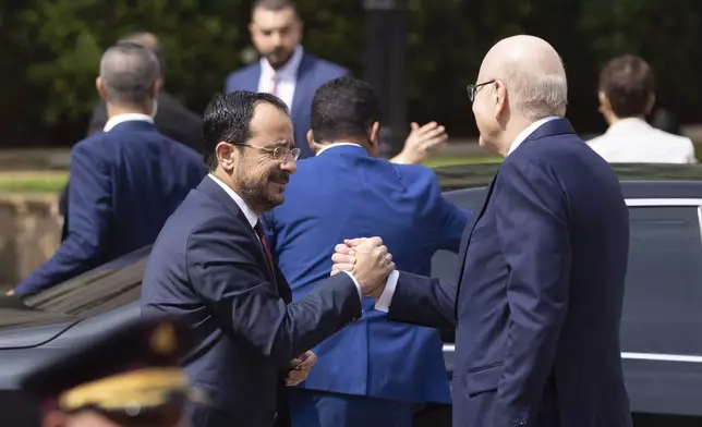 Lebanese caretaker Prime Minister Najib Mikati, right, welcomes Cyprus' president Nikos Christodoulides before their meeting at the government palace in Beirut, Lebanon, Thursday, May 2, 2024. (AP Photo/Hassan Ammar)